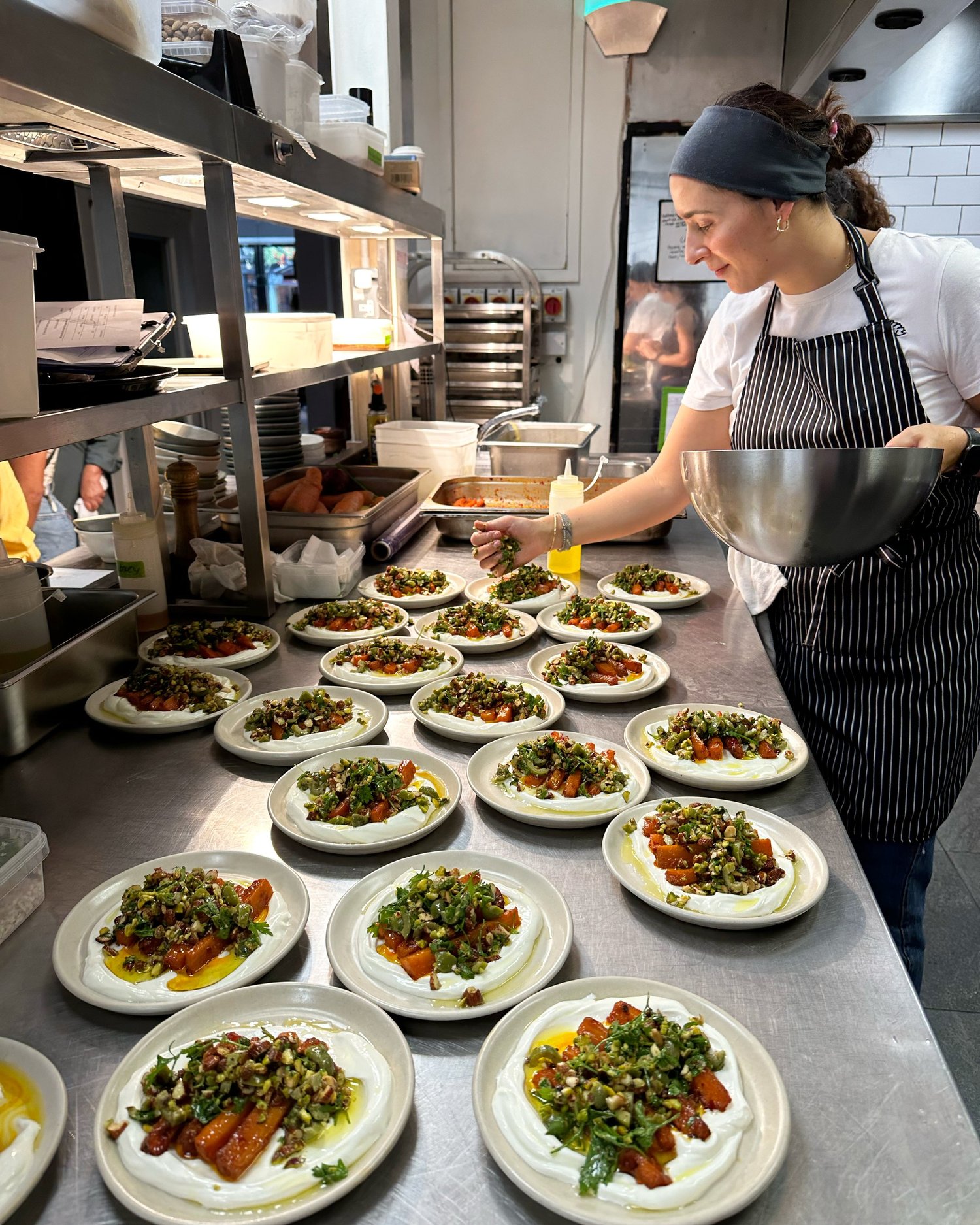 A chef preparing plates in a restaurant kitchen